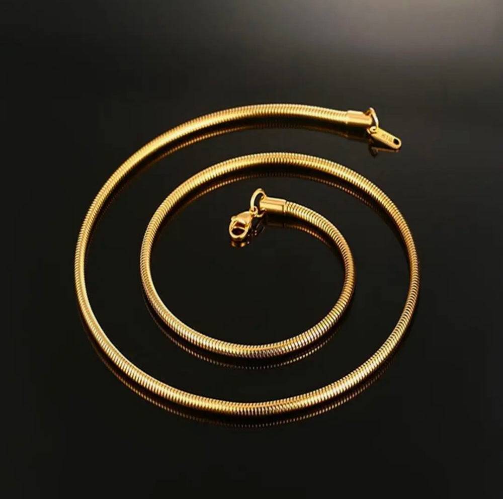 Gold-plated stainless steel snake chain with a sleek, unisex design displayed on a black background. Durable and stylish necklace for men and women.